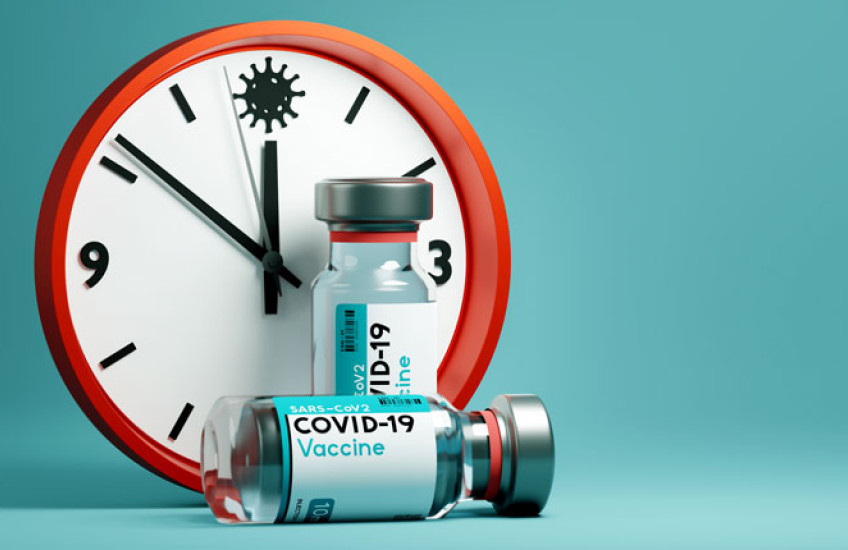 Clock and COVID vaccine vial 