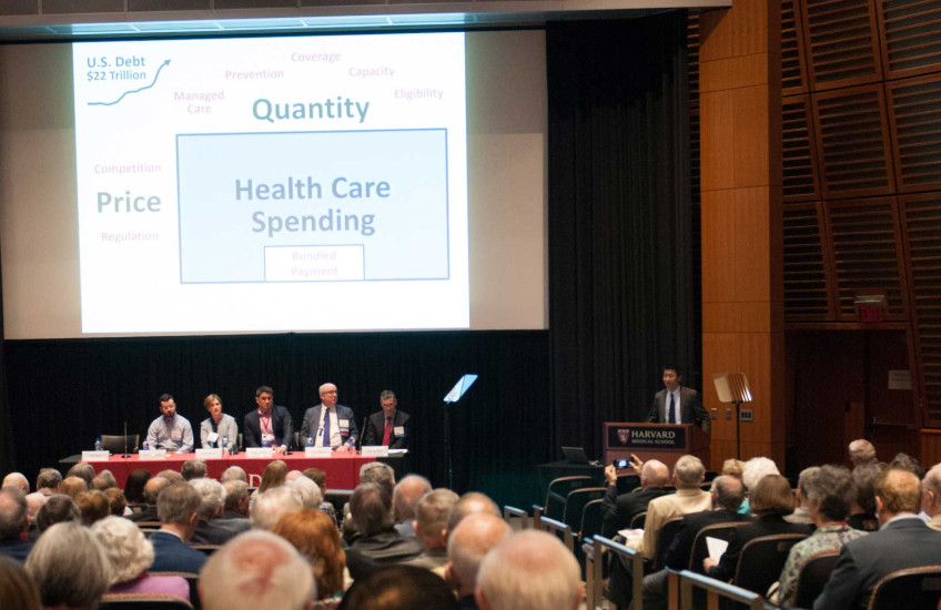 Song, far right, presents while other panelists look on.  