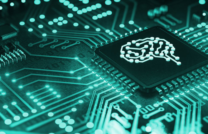 A teal computer circuit board with a simple line drawing of a brain in the center
