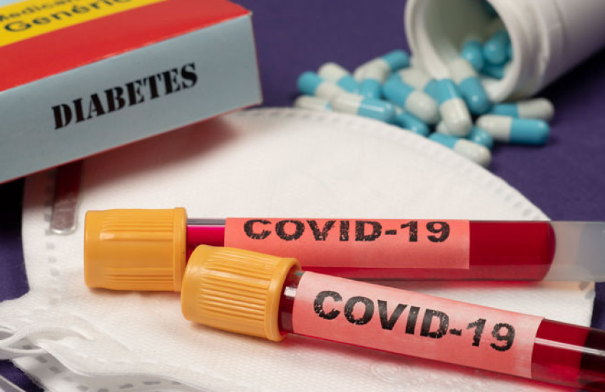 Image of COVID blood test vials with a box nearby that says 'Diabetes' 