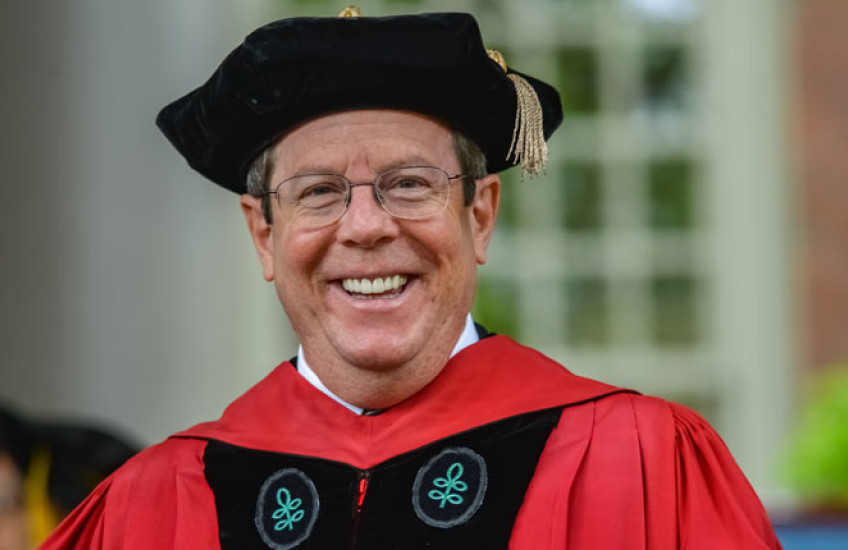 Photo of Hundert at graduation in cap and gown
