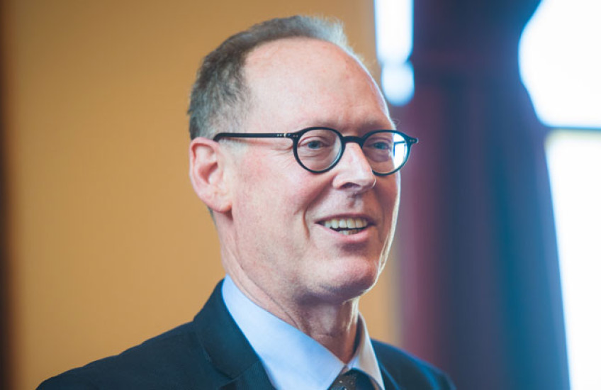 Photo of Paul Farmer in a blue suit 