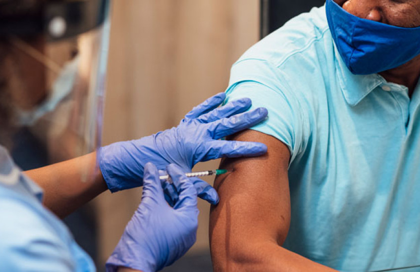 Image of a healthcare worker vaccinating a patient