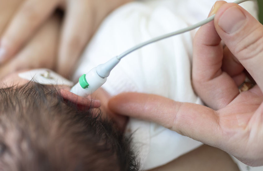 a newborn receiving hearing test