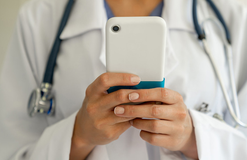 Female physician holding a mobile phone