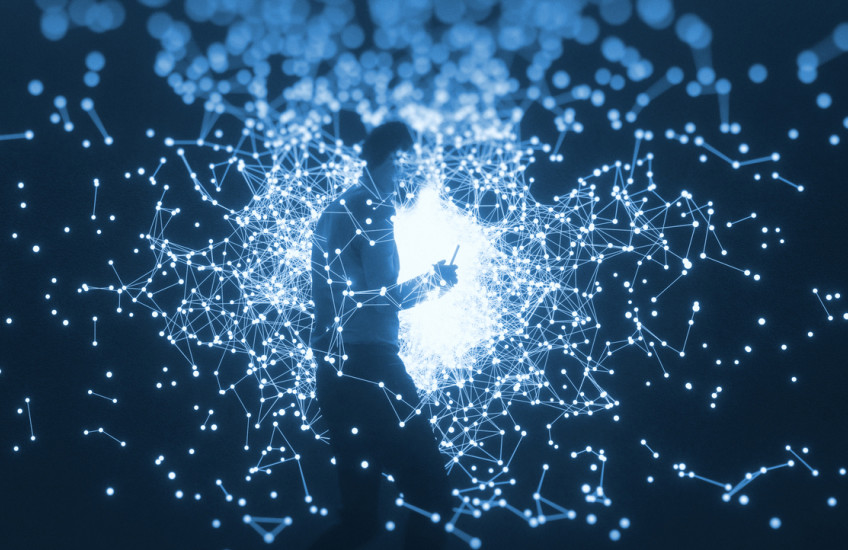 man with cell phone walking through illuminated globes and connecting nodes