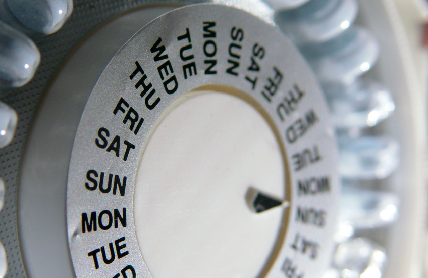 Close-up of a pill organizer listing days of the week.