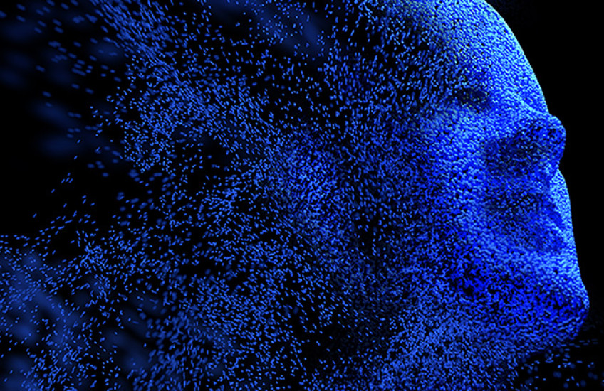 Abstract image of human face in blue dissolving