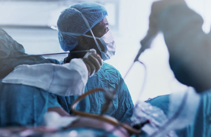 Surgery taking place in a busy operating room.