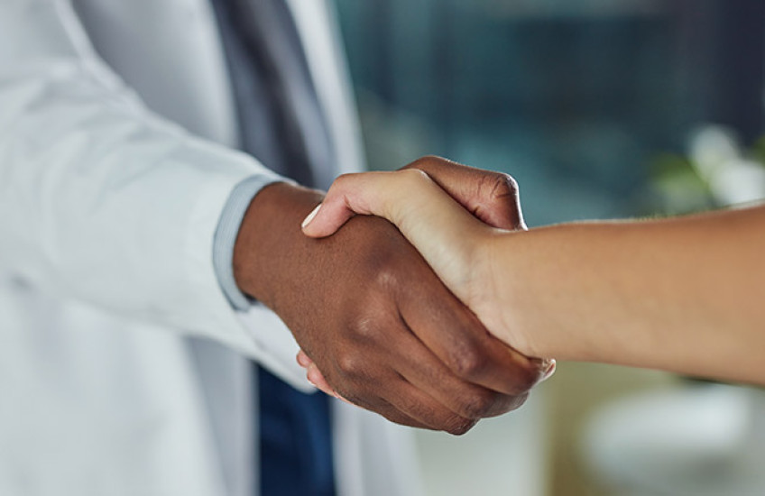 Doctor shaking hand with a patient 