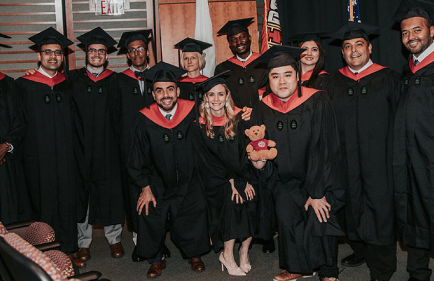a group of master's degree graduates
