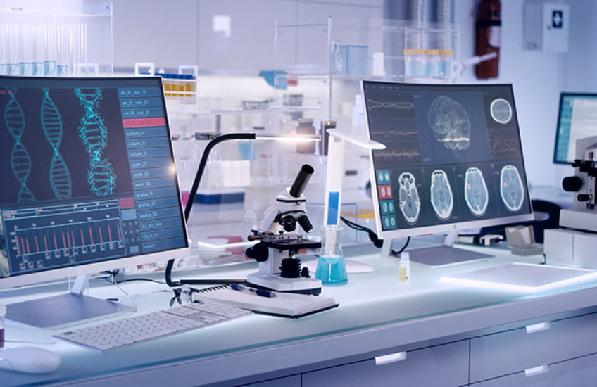 photo of a gleaming modern lab with large computer screens and microscopes