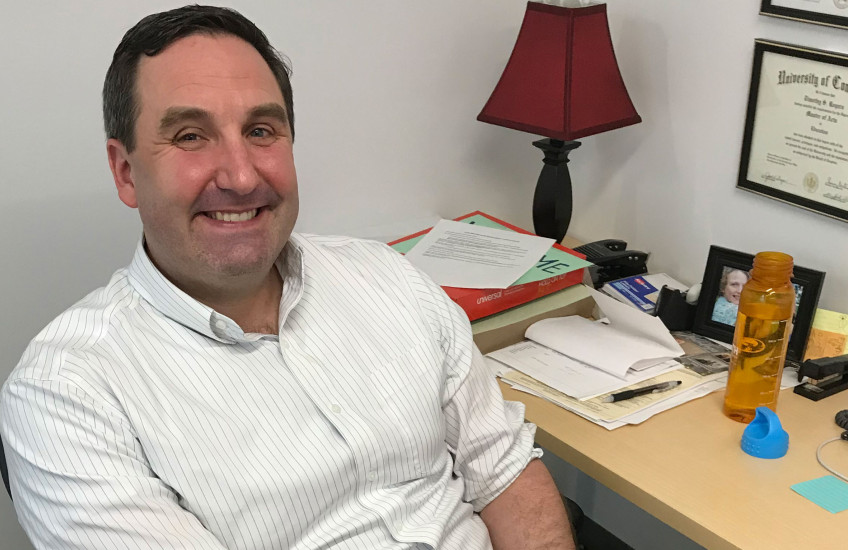 Timothy Rogers sitting at desk