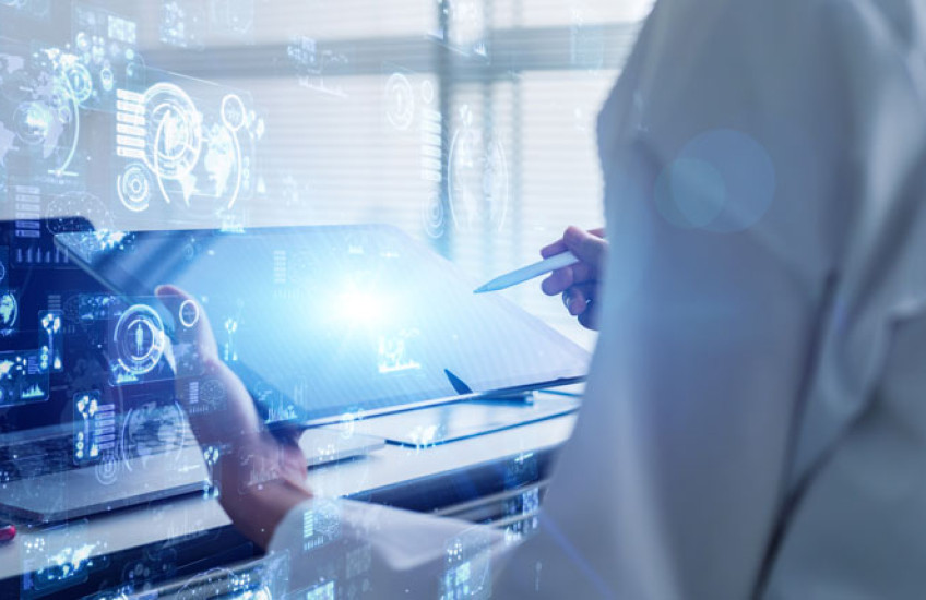 Scientist in white coat holding a table with science concept images overlaid