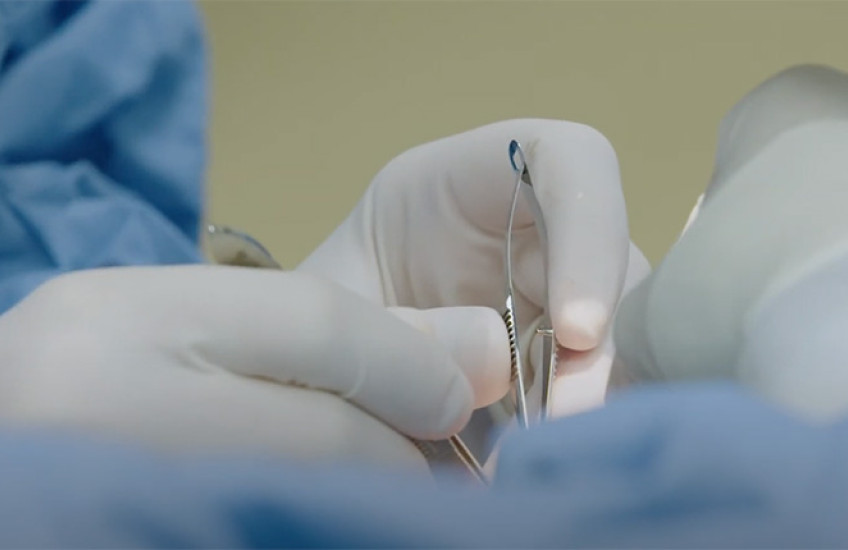 surgeon's hands with implements