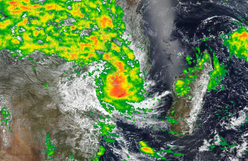 A satelite image of a swirling storm above Malawi and Madagascar, with bands of green, yellow, orange and red showing increasingly intense rainfall.