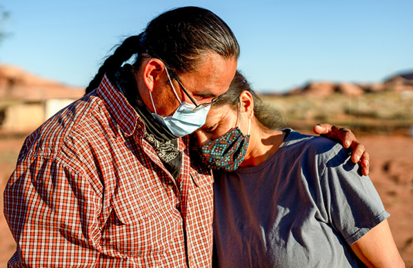 A husband and wife comfort one another during the Coronavirus shutdown on the Navajo nation in Arizona