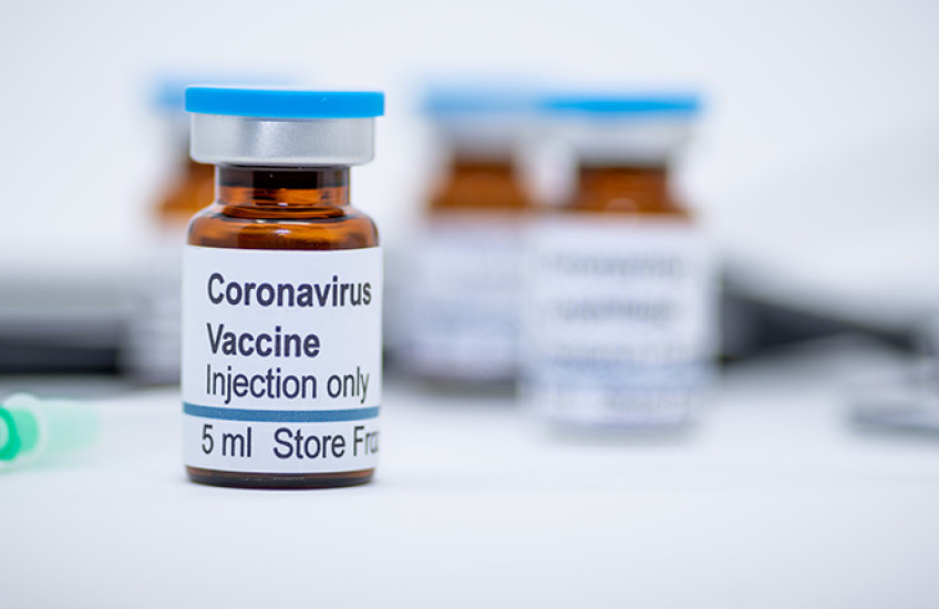 A stock photo showing a medicine bottle labeled "Coronavirus Vaccine, Injection Only, 5 ml."