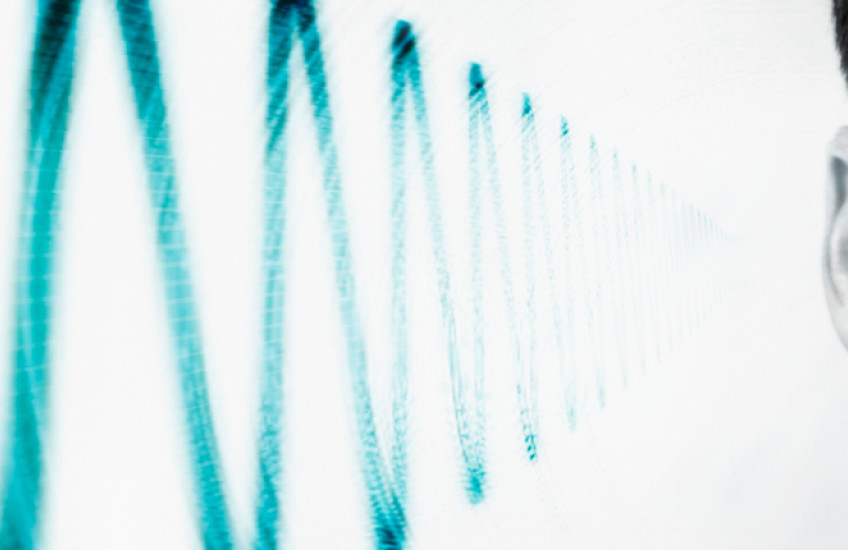 photo of side of man's head showing sound wave near ear
