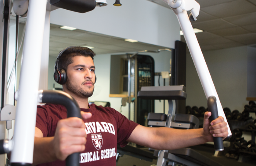 photo of Zaki lifting weights on a chest press machine