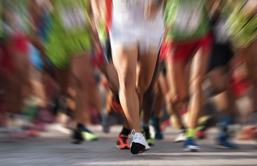 blurred image of runners' legs