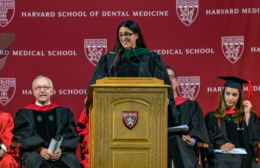Mona Hanna-Attisha infront of the podium addressing the crowd
