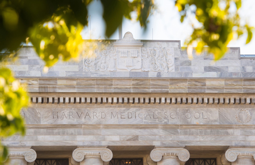 Outdoor photo of Gordon Hall, columned white-marble structure with autumn trees