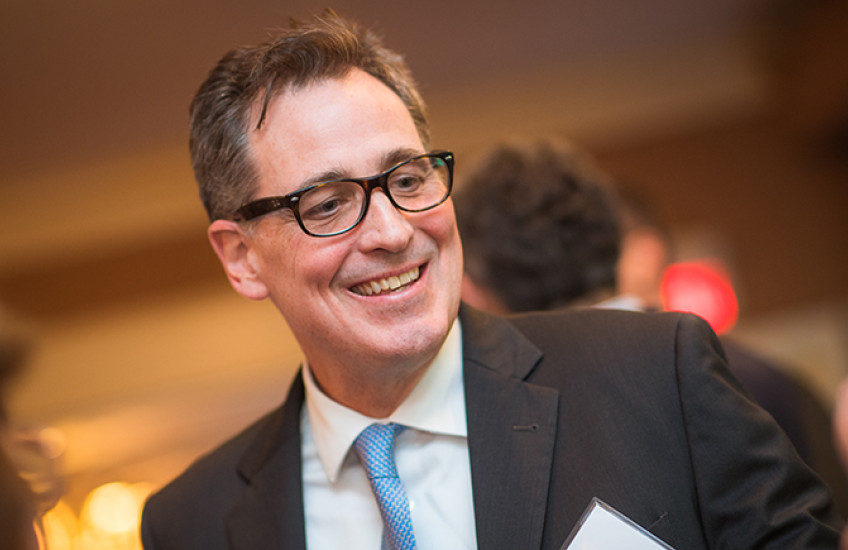 Head shot of a man in glasses and suit