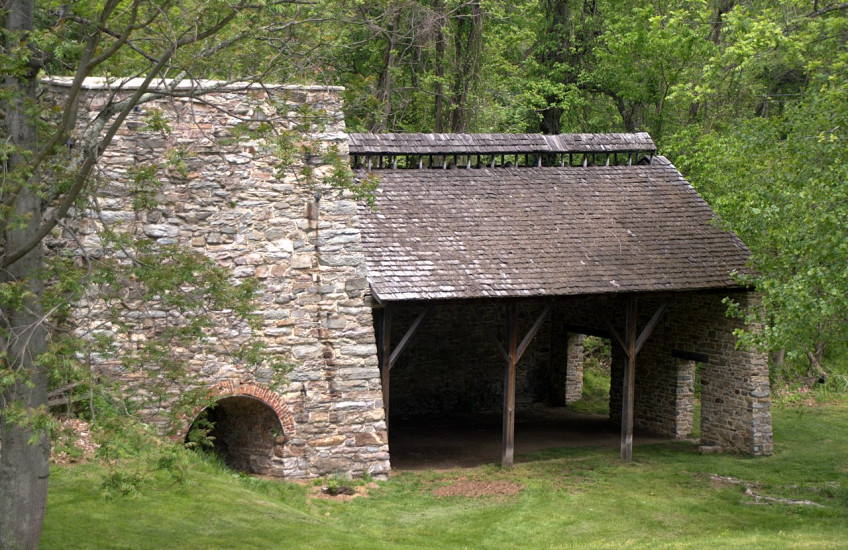 An unoccupied stone building in the woods