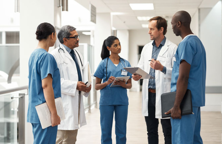 Doctors talking in a group in a hospital 