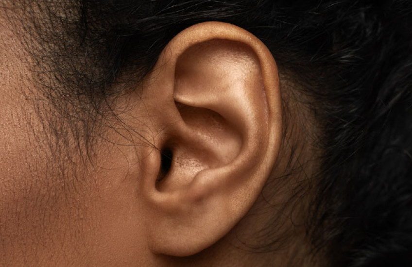 Close up of woman's left ear and cheek 