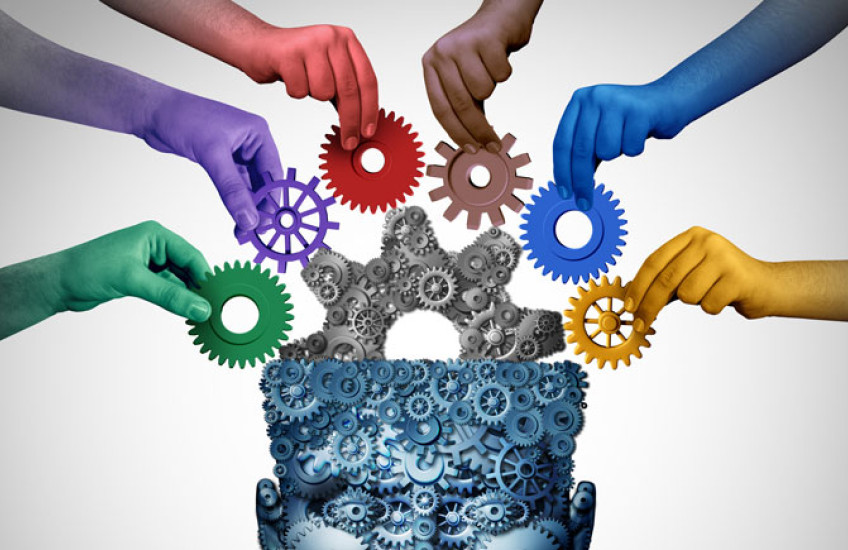 Illustration of hands putting gears into a human head-brain