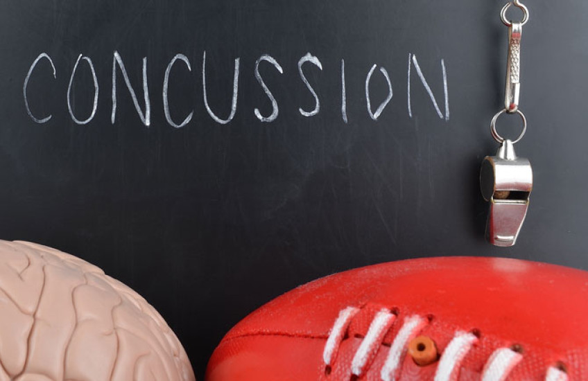 Illustration of a chalkboard that reads "Concussions" with a brain and a football nearby