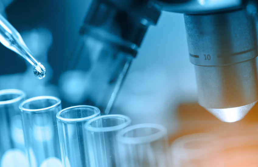 Photo illustration of pipette, test tubes, microscope