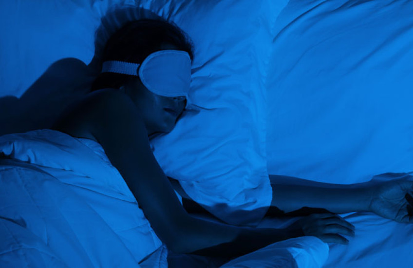person in deep sleep wearing eye mask