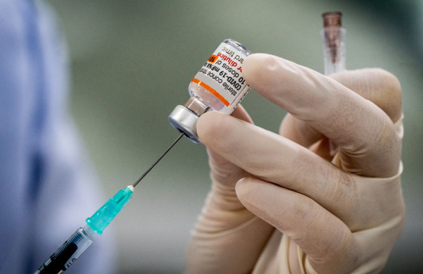 gloved hand with syringe and covid treatment 