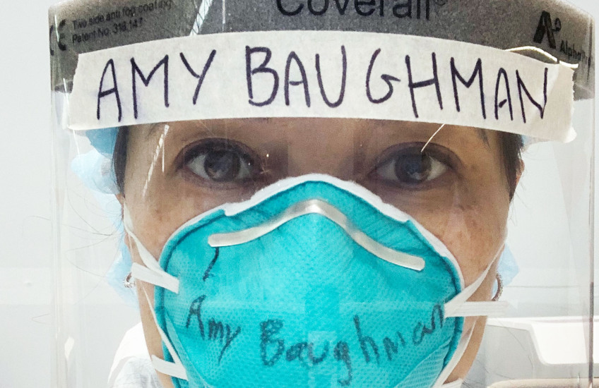 Photo of Amy Baughman MD in full COVID PPE, mask and head gear