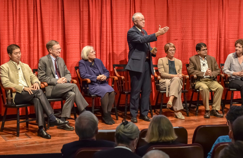 Dean Daley with symposium participants on stage.