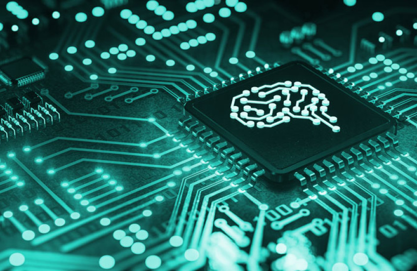 A teal computer circuit board with a simple line drawing of a brain in the center