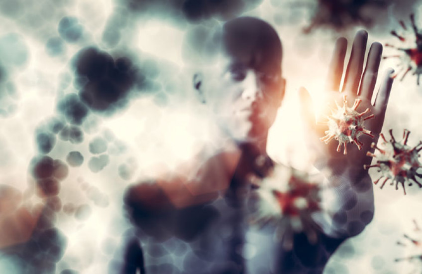 Illustration of a human warding off SARS-CoV2 virus with hand 