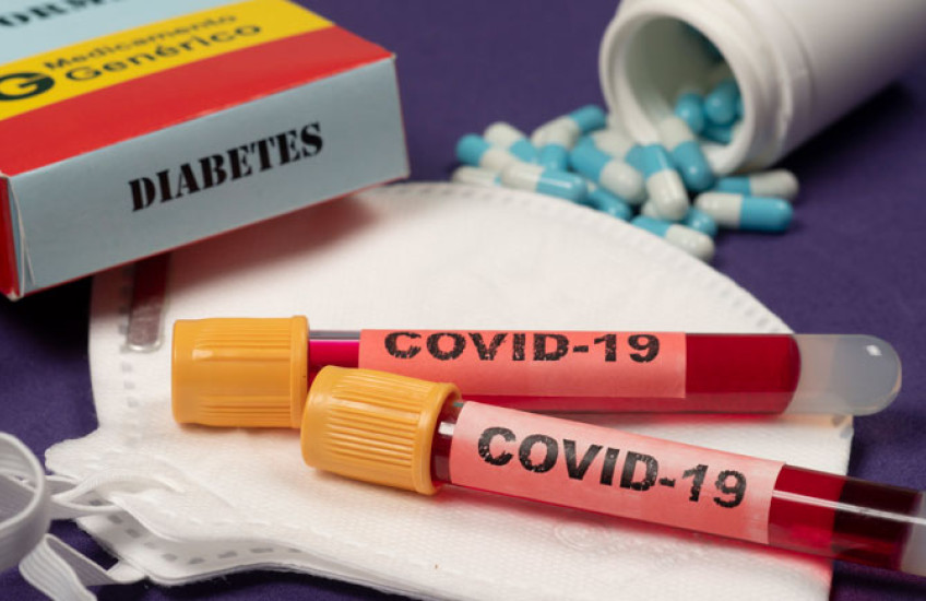 Image of COVID blood test vials with a box nearby that says 'Diabetes' 