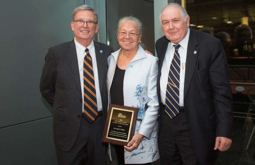 Richard Levin, Nancy Oriol and Ronald Arky displaying the Hurwitz award plaque. 