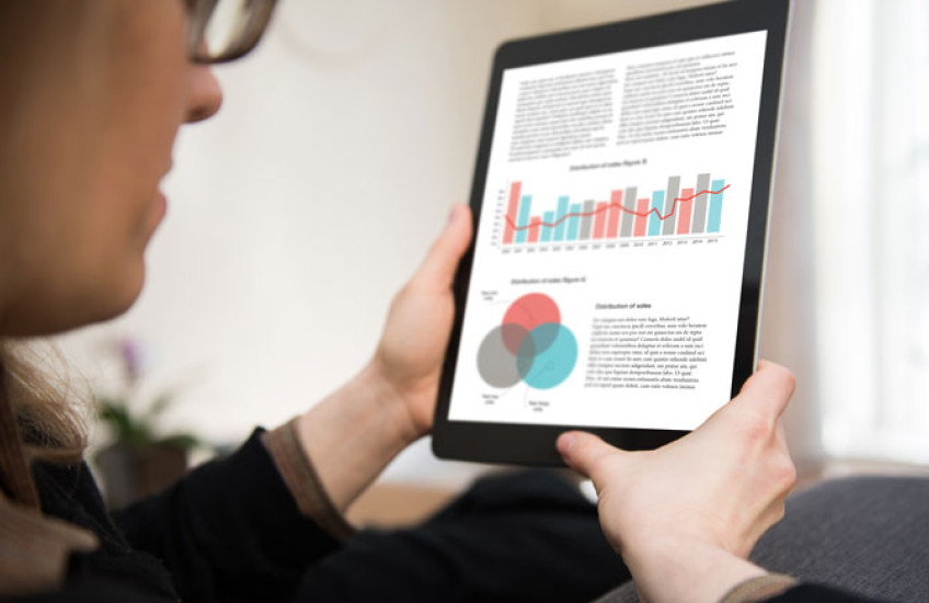 Image of a woman looking at a scientific paper on an iPad