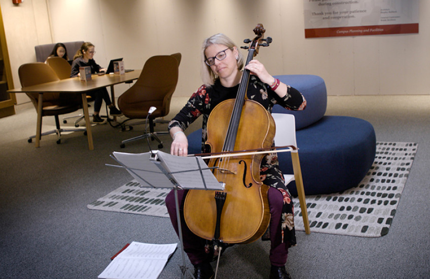 a woman playing cello in Countway Library