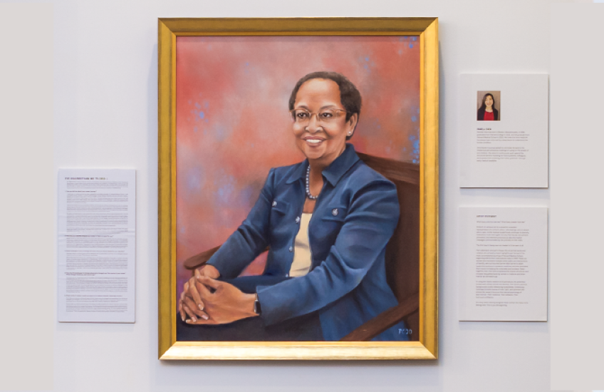 Oil painting of Higginbotham flanked by placards with the artist's bio, Q&A with her, and info about the artwork