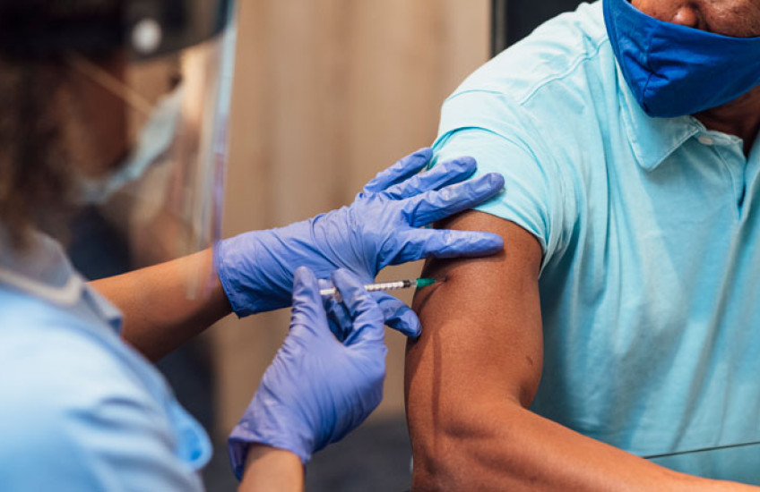 Image of a healthcare worker vaccinating a patient