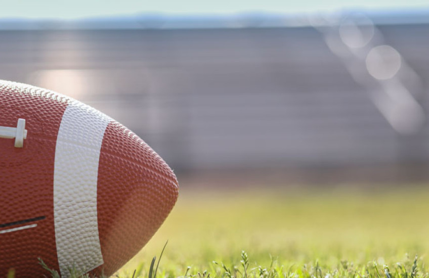 Photo of a football on a grassy field