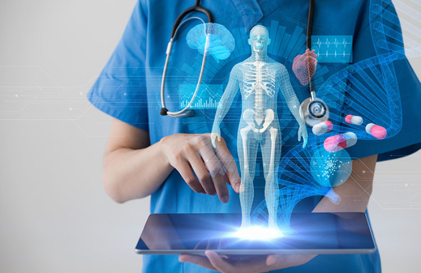 physician holding laptop exploring data