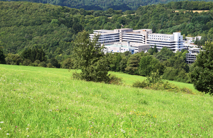 Photo of hospital building in a rural setting in the mountains