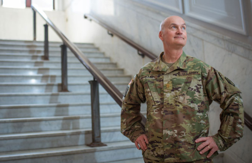 Bain wearing military uniform standing on marble steps with hands on hips